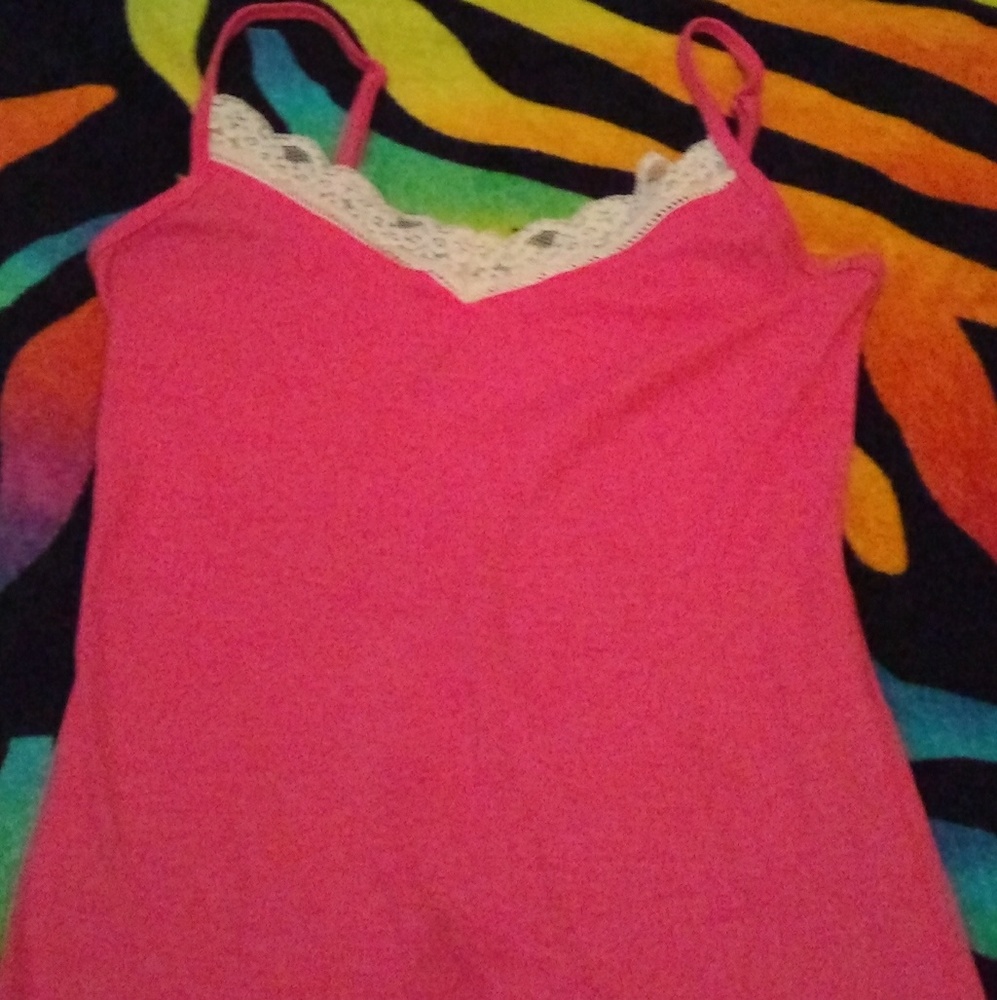 A no sleeve pink and white shirt